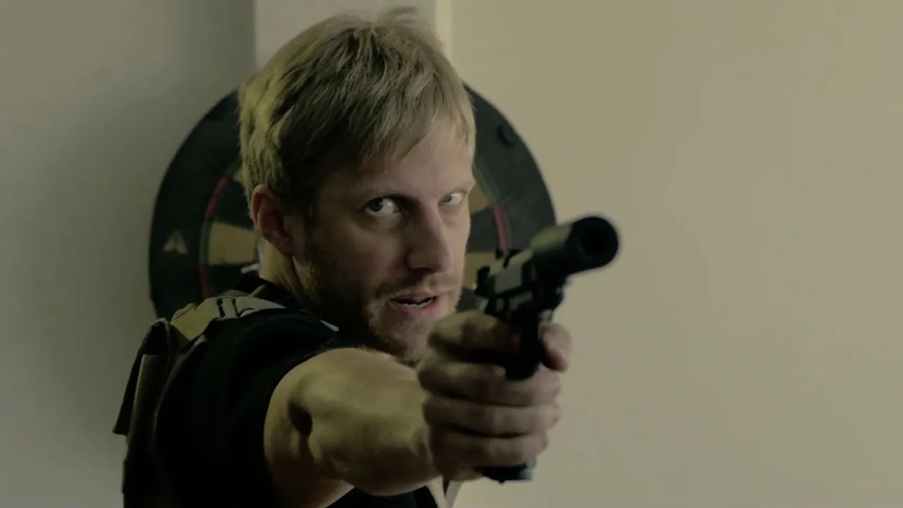 Close-up of an armed operative aiming a suppressed pistol in SYNC